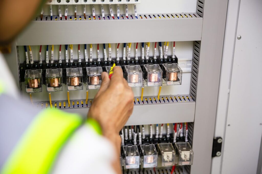 Electrician working on a residential circuit breaker panel in Greensboro