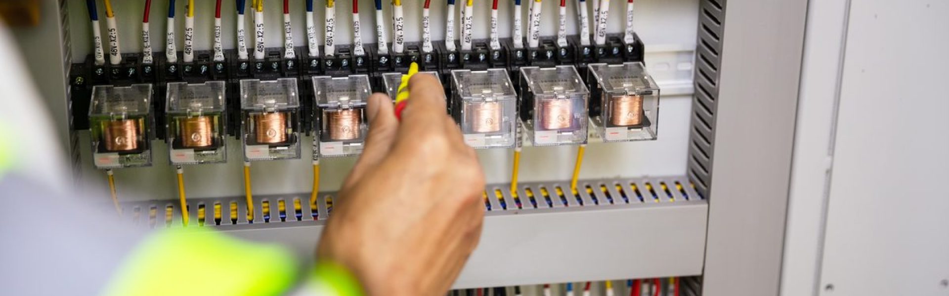 Electrician working on a residential circuit breaker panel in Greensboro
