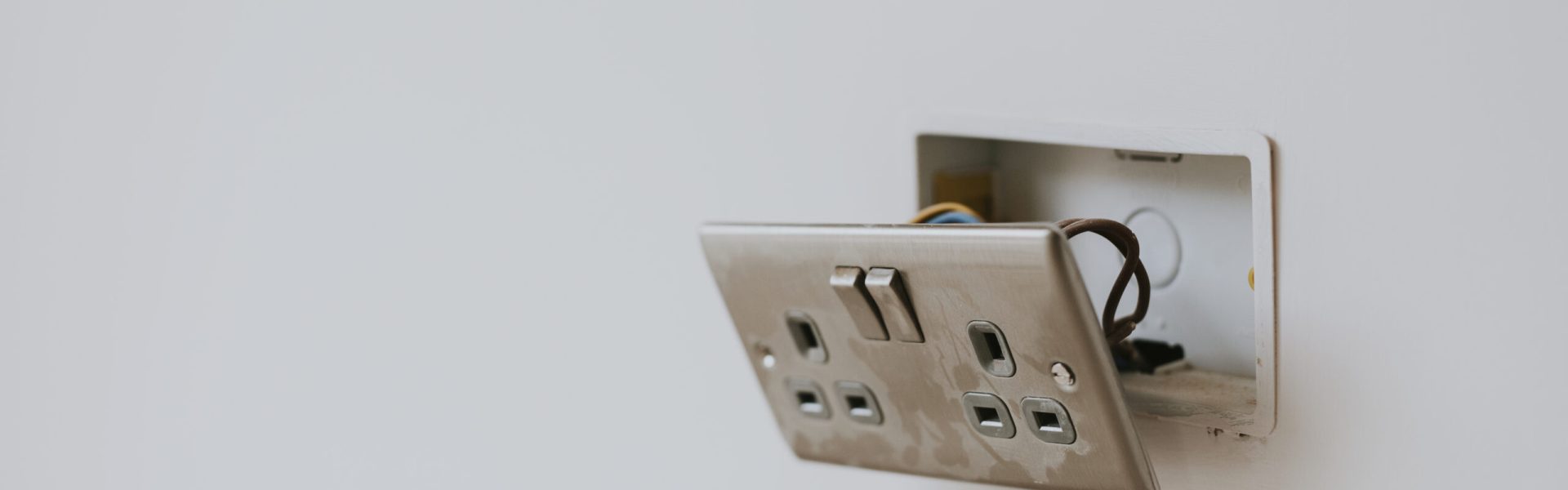 Broken power outlet on the wall